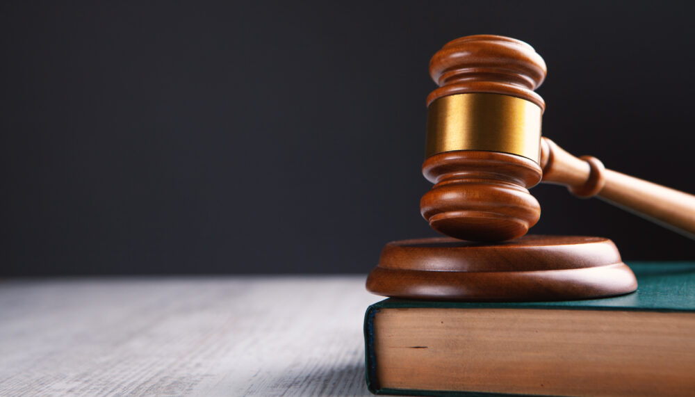 Wooden judge gavel and law books.